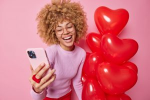 Good looking young woman makes receives Valentine's Day surprise